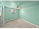 Light green bedroom featuring neutral carpet, ceiling fan, and window AC unit at 3928 Cherry Way, Lakeland, FL 33805