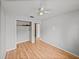 Bedroom with wood floors, a ceiling fan, and a built-in closet at 3928 Cherry Way, Lakeland, FL 33805