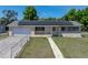Charming single-story home showcasing solar panels, a front yard, and a classic design at 3928 Cherry Way, Lakeland, FL 33805