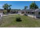 Exterior shot of single-Gathering home with solar panels and green grass at 3928 Cherry Way, Lakeland, FL 33805