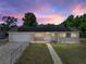 Charming single-story home showcasing solar panels, a front yard, and a classic design at 3928 Cherry Way, Lakeland, FL 33805