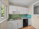 Kitchen featuring white cabinets, a stainless steel sink, and a black dishwasher at 3928 Cherry Way, Lakeland, FL 33805