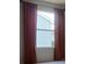 Bedroom featuring a window with rust-colored curtains at 1219 Santos Pl, Lady Lake, FL 32159