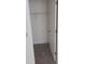 A small, empty closet with carpeted flooring and one shelf at 1219 Santos Pl, Lady Lake, FL 32159