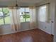 Bright dining area featuring wood-look floors, many windows, and chandelier at 1219 Santos Pl, Lady Lake, FL 32159