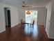 Spacious dining area with wood floors, an ornate light fixture, and connections to multiple rooms at 1219 Santos Pl, Lady Lake, FL 32159