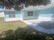 Home entrance showcasing a tidy gravel area, concrete pavers, a white door, and bright windows at 1219 Santos Pl, Lady Lake, FL 32159