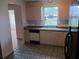 Well-lit kitchen with light wood cabinetry, black dishwasher, and a double basin sink at 1219 Santos Pl, Lady Lake, FL 32159