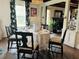 Inviting dining room with floral curtains, a round table, and open access to a cozy living area at 18700 Ravenswood Rd, Altoona, FL 32702