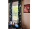 Charming entryway featuring floral curtains, modern artwork, and a decorative seashell at 18700 Ravenswood Rd, Altoona, FL 32702