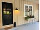 Welcoming entryway features a classic black door, stylish lighting, and a charming window box at 18700 Ravenswood Rd, Altoona, FL 32702