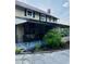 Charming front porch with ornate railings, hanging plants and a small garden at 18700 Ravenswood Rd, Altoona, FL 32702
