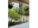 Front porch showcasing hanging plants, ornate railings, and a view of lush greenery at 18700 Ravenswood Rd, Altoona, FL 32702