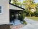 Charming front porch with decorative iron railings and well-manicured landscaping, creating a welcoming entrance at 18700 Ravenswood Rd, Altoona, FL 32702