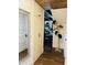 Hallway featuring closet, wood plank floors, hat rack and view into living space at 18700 Ravenswood Rd, Altoona, FL 32702