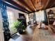 Bright living room with a dark fireplace, lots of plants, and views to the outside at 18700 Ravenswood Rd, Altoona, FL 32702