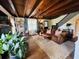 Cozy living room with exposed wood beams, brick fireplace, and comfortable seating for relaxing at 18700 Ravenswood Rd, Altoona, FL 32702