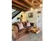 Comfortable living room with a brown couch, wooden coffee table, and stairs to the left at 18700 Ravenswood Rd, Altoona, FL 32702