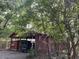 Rustic, covered back yard outbuilding with equipment at 18700 Ravenswood Rd, Altoona, FL 32702