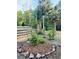 View of the fenced pool area featuring a wood fence, palm trees, and mulch landscaping at 18700 Ravenswood Rd, Altoona, FL 32702
