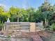 View of the pool area surrounded by a wood fence and lush greenery at 18700 Ravenswood Rd, Altoona, FL 32702