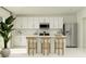 Modern kitchen features stainless steel appliances, white cabinets, and a stylish island with seating at 4734 Bold Peacock Bnd, Bartow, FL 33830