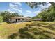 Large fenced backyard with lush lawn and sunny patio for outdoor enjoyment at 933 W Queen St, Lakeland, FL 33803