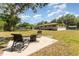 Spacious backyard featuring a fire pit and seating area, perfect for outdoor entertaining at 933 W Queen St, Lakeland, FL 33803