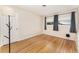 Inviting bedroom with hardwood floors and natural light from two windows at 933 W Queen St, Lakeland, FL 33803