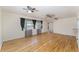 Sunlit living room with hardwood floors and open floorplan, creating a warm and inviting space at 933 W Queen St, Lakeland, FL 33803