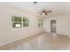 Bright living room featuring tile flooring, neutral walls, and a ceiling fan at 933 W Queen St, Lakeland, FL 33803