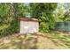 Backyard shed next to greenery and a green chain link fence at 933 W Queen St, Lakeland, FL 33803