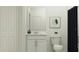Neat and organized bathroom featuring a modern vanity, mirror, and a toilet, creating a functional and stylish space at 971 Hour Glass Rd, Lakeland, FL 33801