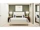 Beautifully staged bedroom with an olive accent wall and neutral decor at 971 Hour Glass Rd, Lakeland, FL 33801