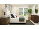 Bright bedroom with a large window, modern decor, and a comfortable bed setting, complemented by stylish furnishings at 971 Hour Glass Rd, Lakeland, FL 33801
