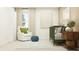 Cozy Bedroom featuring a crib, comfortable chair, and soft, natural light at 971 Hour Glass Rd, Lakeland, FL 33801