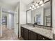 Bathroom featuring dark cabinets, granite counters, tiled floor and a view to another room at 490 N Pin Oak Pl # 112, Longwood, FL 32779