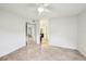 Bright bedroom boasts neutral tile flooring, ensuite bathroom, and open layout, ideal for relaxation and personalization at 490 N Pin Oak Pl # 112, Longwood, FL 32779