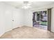 Relaxing bedroom featuring tile floors, ceiling fan, access to a private lanai overlooking a serene outdoor setting at 490 N Pin Oak Pl # 112, Longwood, FL 32779