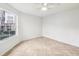 Inviting bedroom features neutral tile flooring, a ceiling fan, and a large window offering abundant natural light at 490 N Pin Oak Pl # 112, Longwood, FL 32779