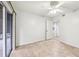 Cozy bedroom featuring neutral tile flooring and access to the lanai, creating a seamless transition to outdoor living at 490 N Pin Oak Pl # 112, Longwood, FL 32779