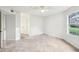 Bright, empty room featuring tiled flooring, a ceiling fan, a large window and fresh paint at 490 N Pin Oak Pl # 112, Longwood, FL 32779