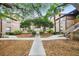 Beautiful courtyard with lush landscaping, mature trees, and inviting walkways, offering a serene and tranquil environment at 490 N Pin Oak Pl # 112, Longwood, FL 32779