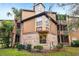 Exterior view of a brick and sided condo with a bay window and mature landscaping at 490 N Pin Oak Pl # 112, Longwood, FL 32779