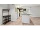 Bright kitchen features white appliances, dark cabinets and tile flooring, plus a granite counter topped kitchen island at 490 N Pin Oak Pl # 112, Longwood, FL 32779