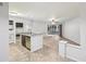 Open floor plan featuring a kitchen island with granite countertops, a sliding glass door leading to the patio and tile flooring at 490 N Pin Oak Pl # 112, Longwood, FL 32779