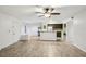 Spacious open-concept living room and kitchen featuring tiled floors and modern lighting fixtures at 490 N Pin Oak Pl # 112, Longwood, FL 32779
