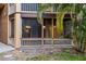Charming screened patio with wood railing and supporting posts overlooking a lawn area with tall palm trees at 490 N Pin Oak Pl # 112, Longwood, FL 32779