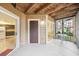 Inviting outdoor patio featuring a wood plank ceiling, door leading to inside and screened-in enclosure at 490 N Pin Oak Pl # 112, Longwood, FL 32779