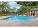 Community pool with a gazebo, sun loungers, and lush tropical landscaping at 490 N Pin Oak Pl # 112, Longwood, FL 32779